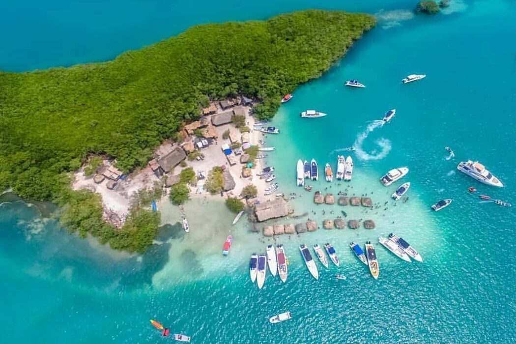 island with many boats around it